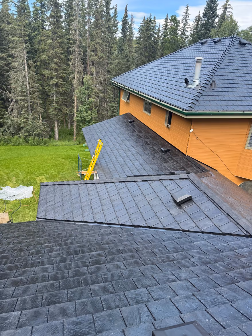 Aerial overview synthetic slate roof acreage home