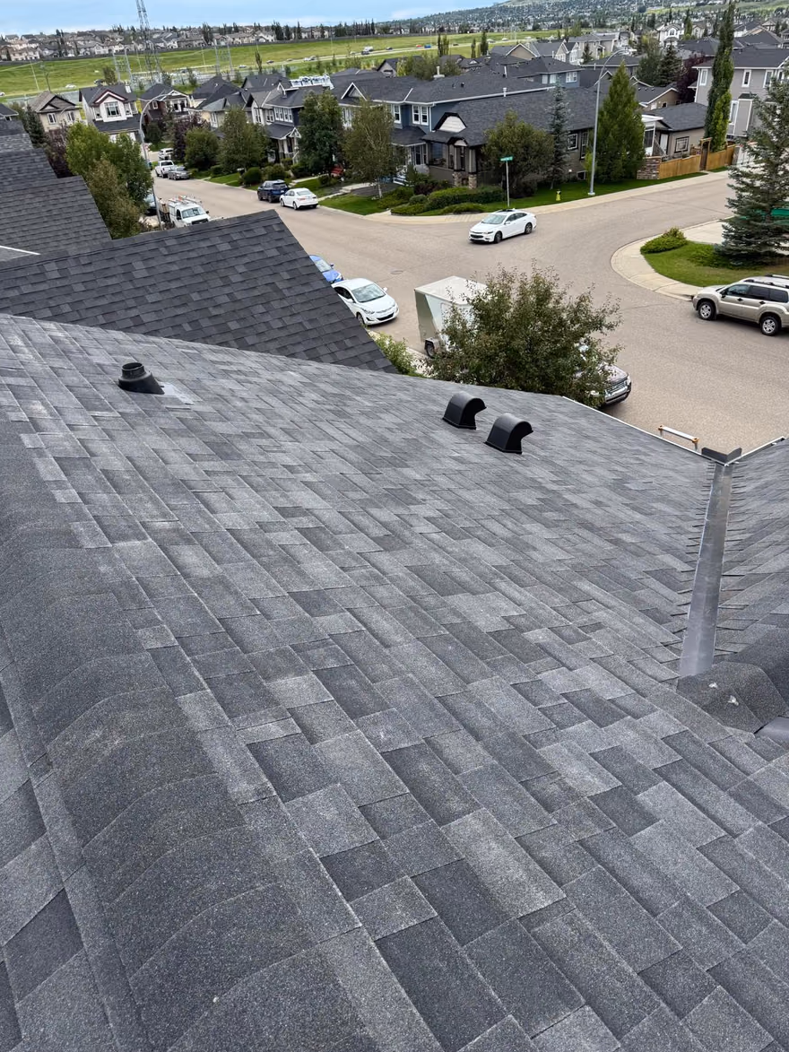 Aerial view finished shingle roof over cul de sac