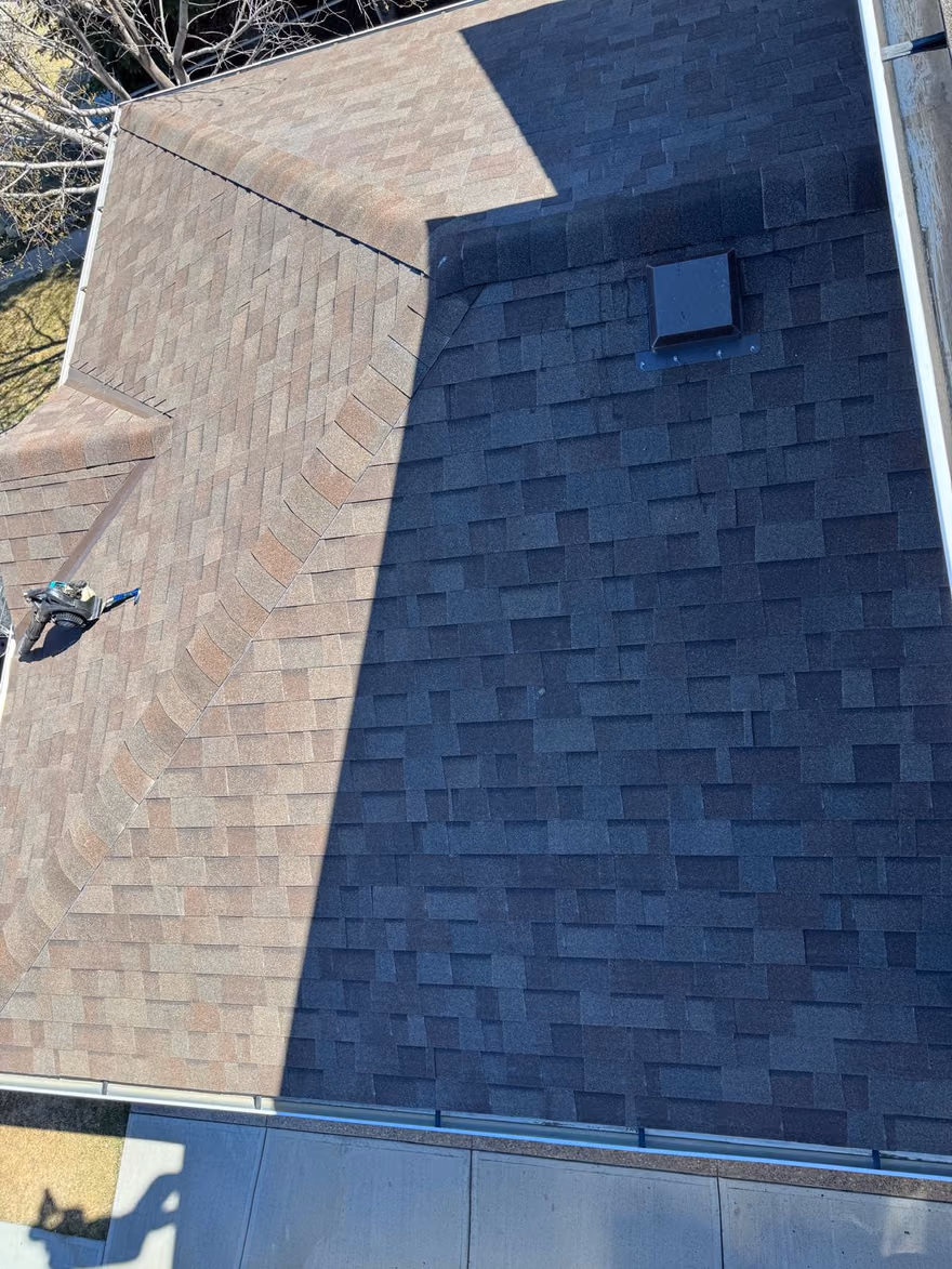 Aerial view two tone shingle roof sections and vent