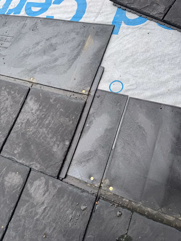 Close up synthetic slate shingles nailed in courses