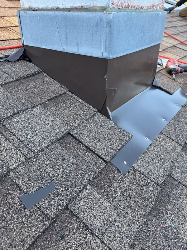 Completed chimney flashing shingle tie in from ladder