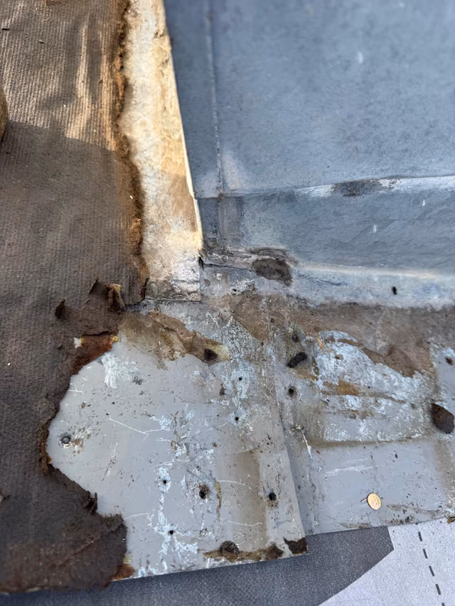 Corroded chimney step flashing water damaged decking