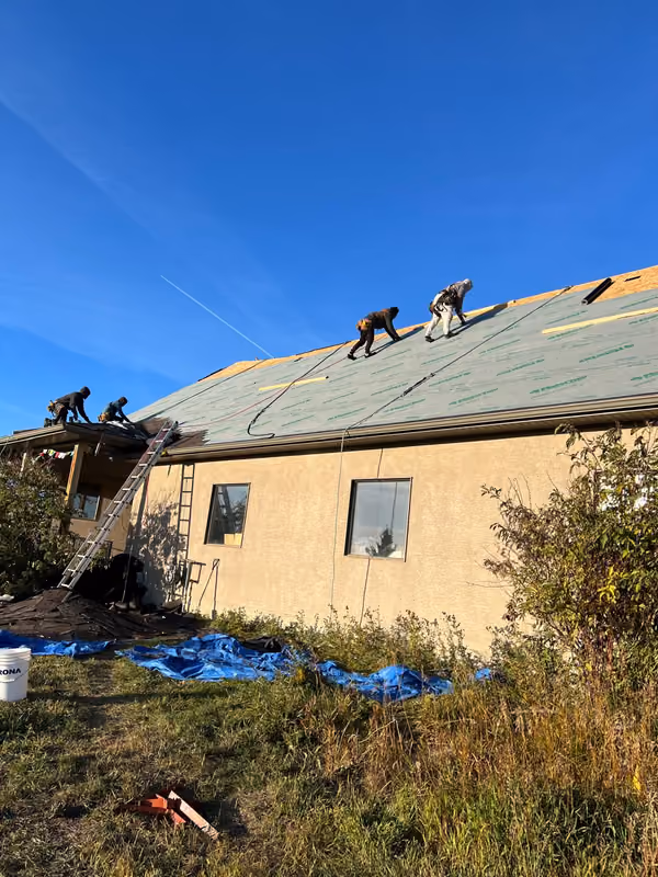 Crew and ladders at bungalow eave tarps below