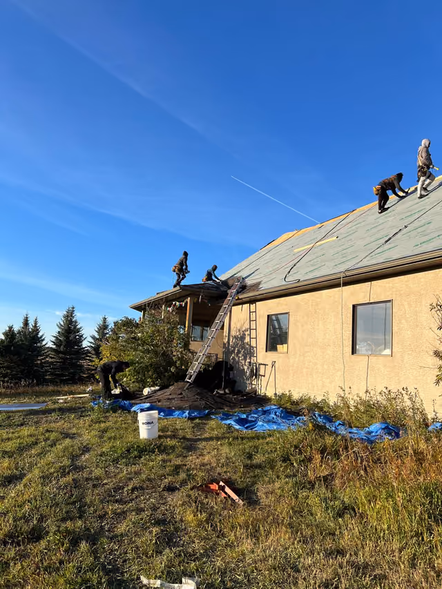 Crew working along ridge ladder access ground view