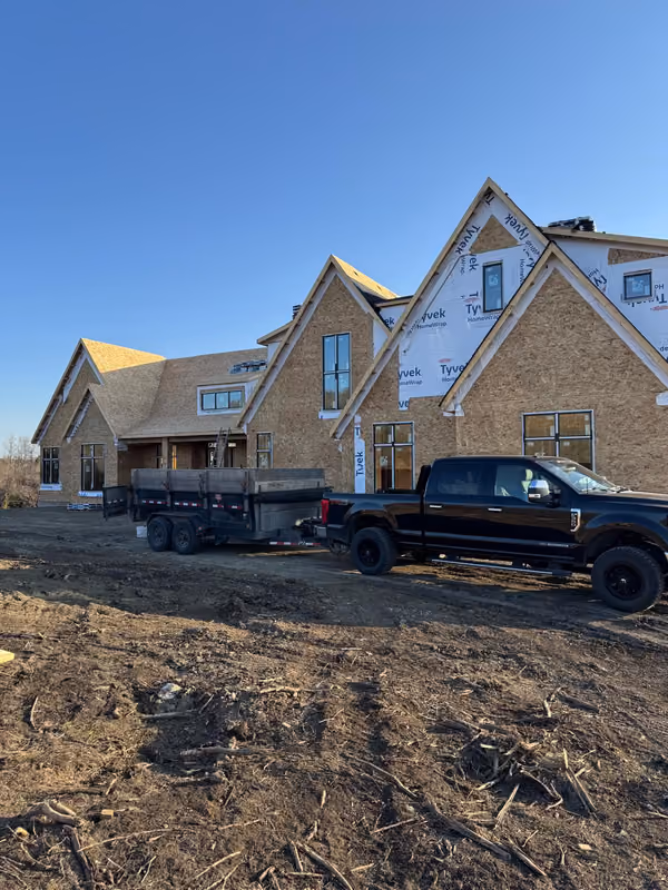 Dump trailer and truck parked at new build jobsite