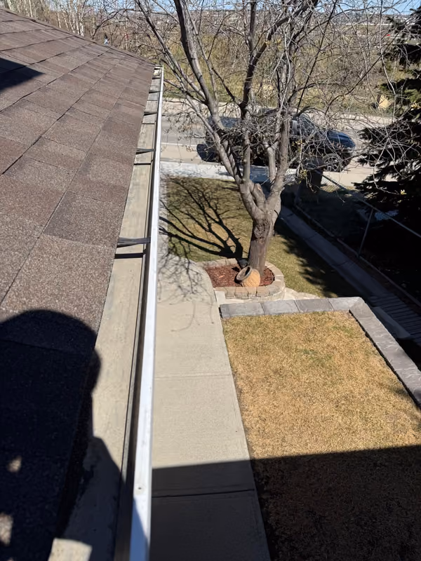 Eavestrough run along eave from roof vantage