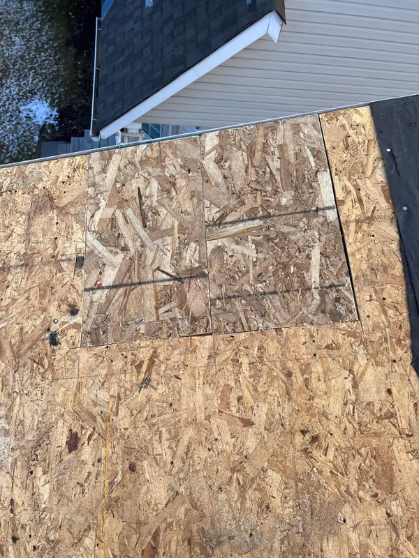 Exposed OSB deck beside white soffit fascia