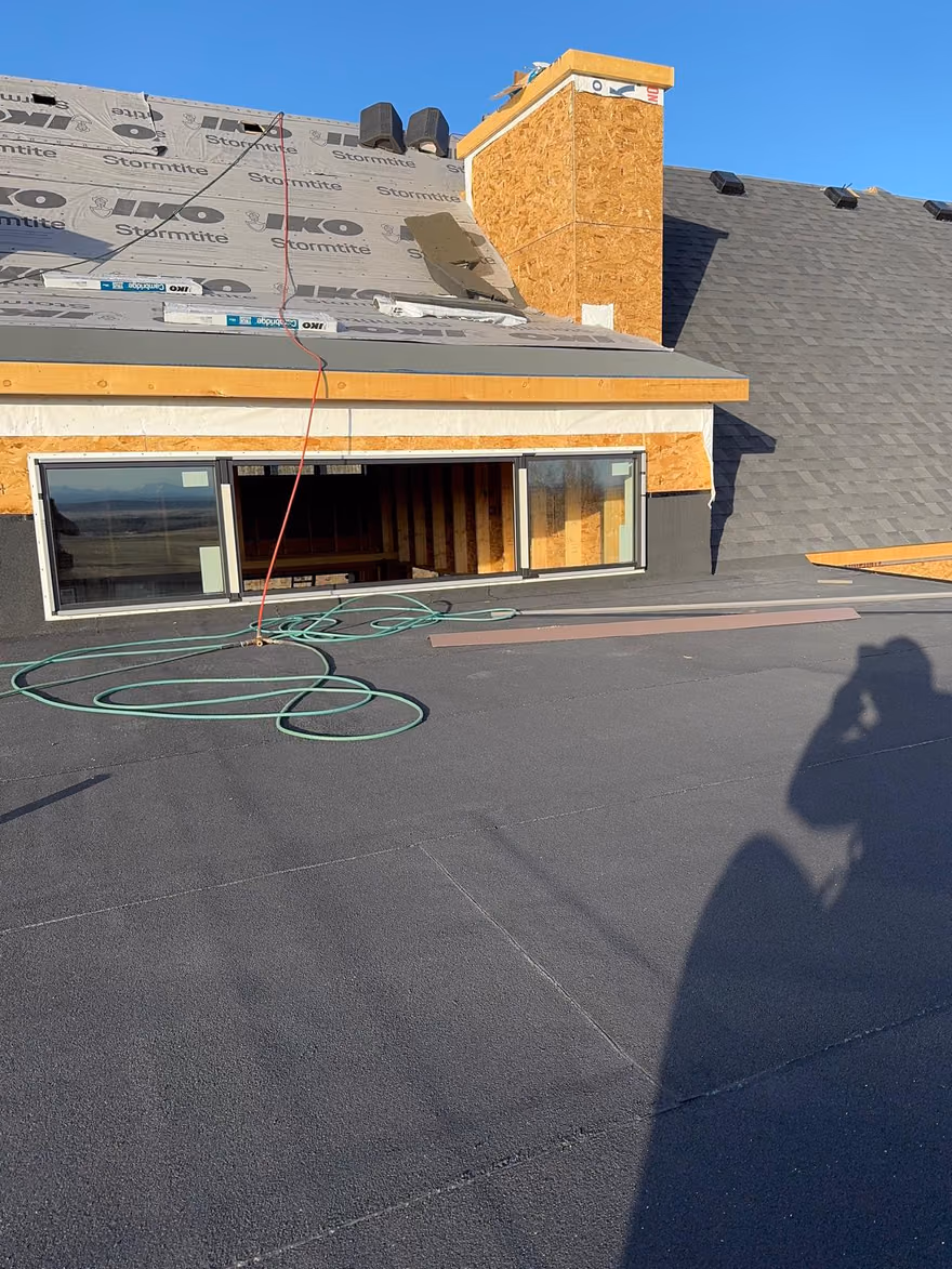Flat membrane roof deck with hose and house wrap walls
