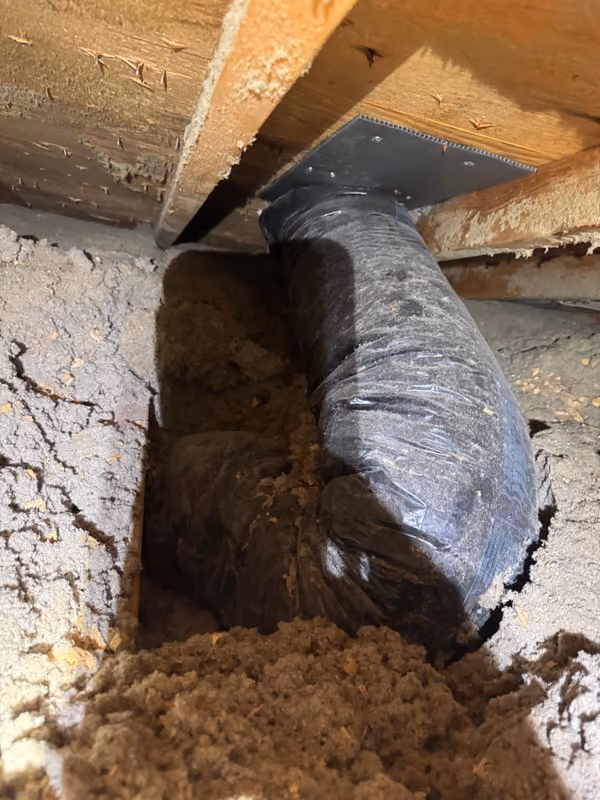 Insulated flex duct connection to roof vent in attic