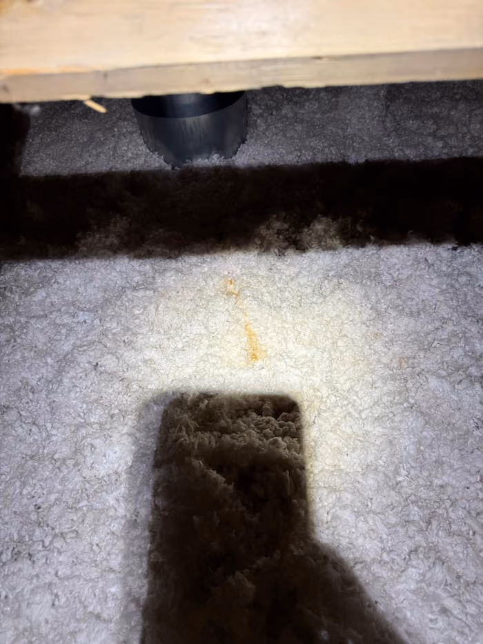 Interior attic blown in insulation around vent duct