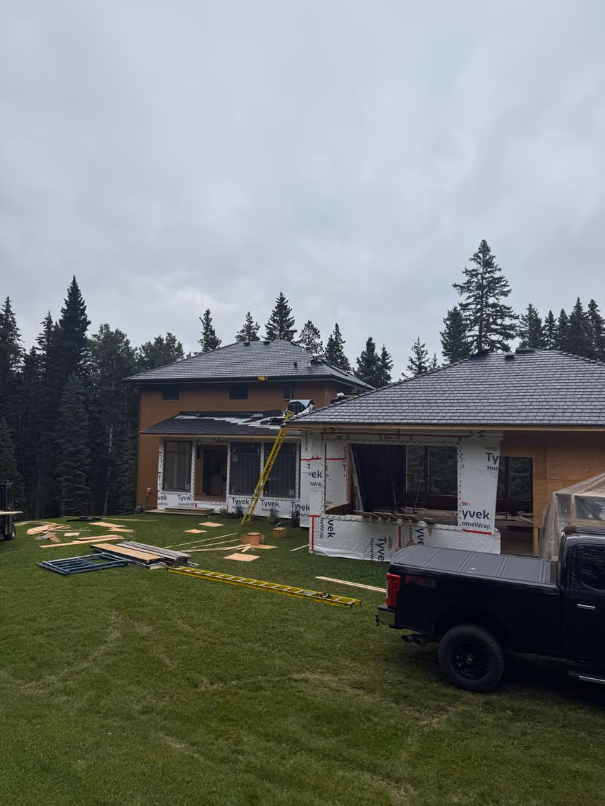 Job site view with ladder and roofing truck