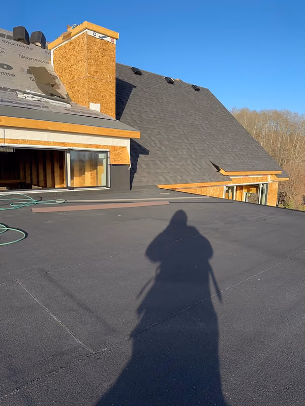 Low slope deck looking toward shingled main roof