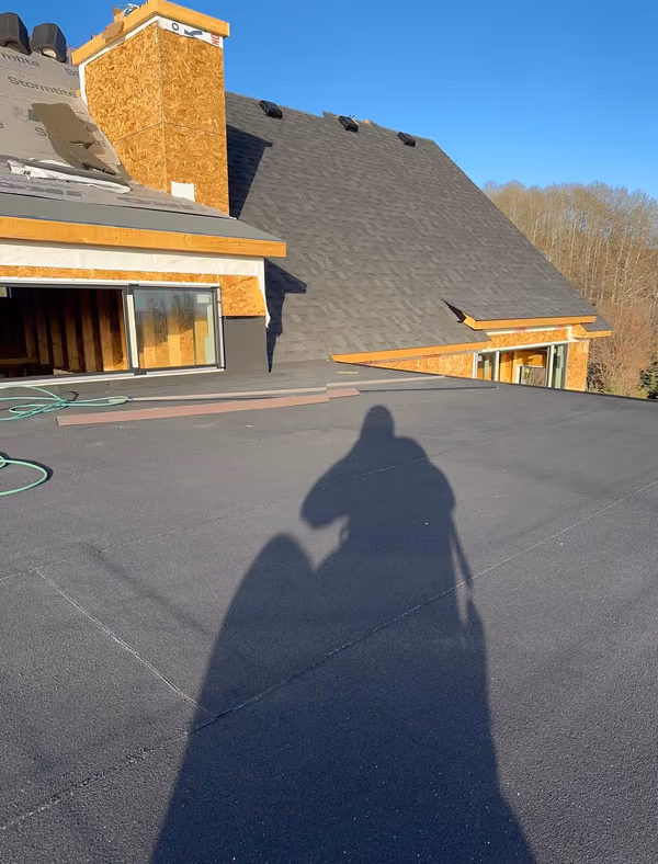 Membrane deck and large shingled hip roof new build