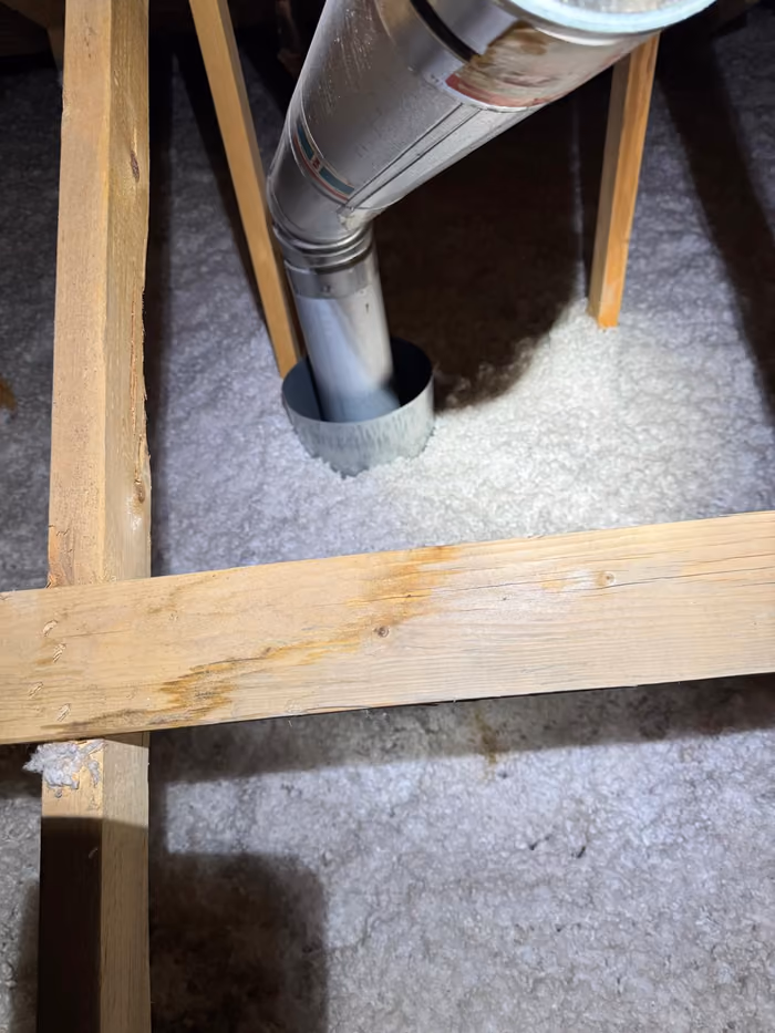 Metal duct terminating into attic blown in insulation