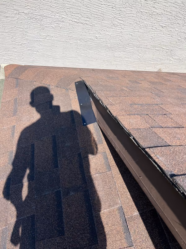 Metal flashing along roof to wall junction close up