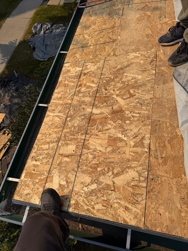 New OSB sheathing installed over garage roof deck