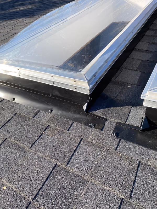 New skylight set on curb with shingles around