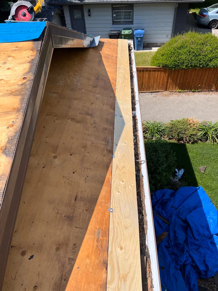 New valley metal on plywood deck tarped yard