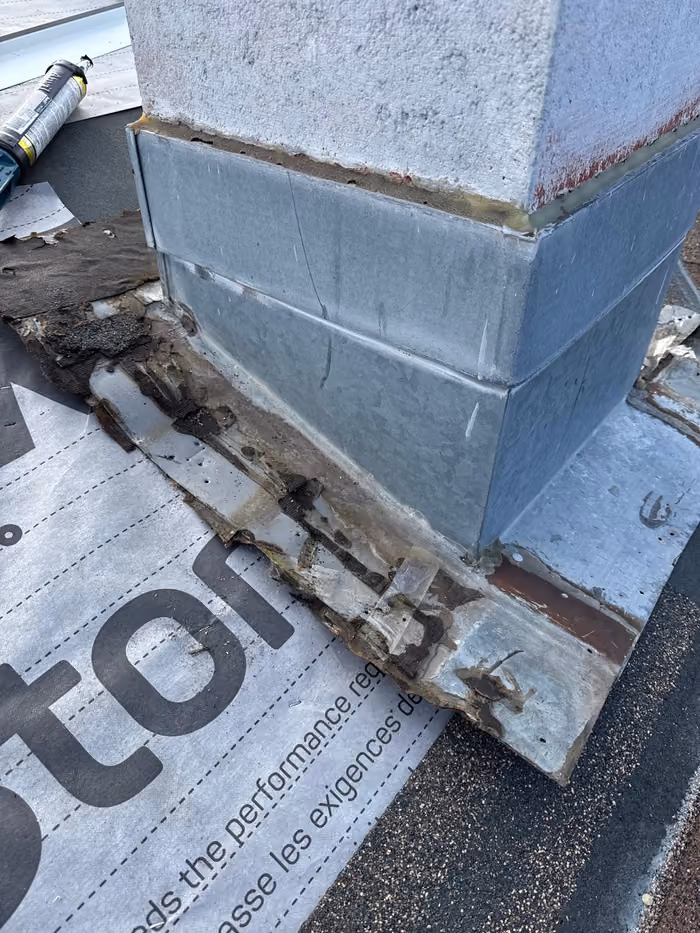 Old chimney flashing stripped back exposing rotted wood