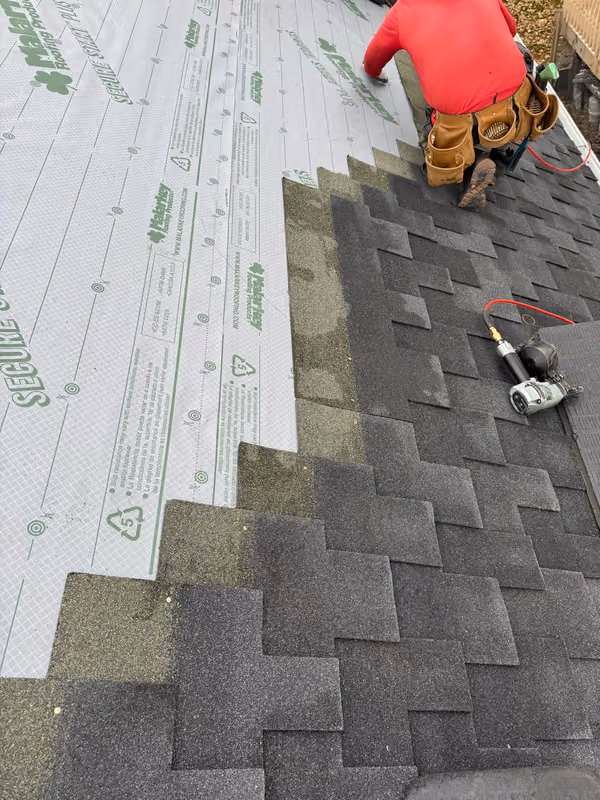 Roofer nailing shingle courses over synthetic underlayment