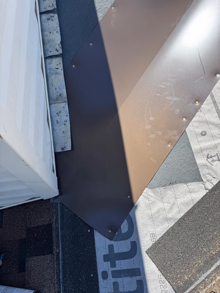 Sidewall metal flashing installed over underlayment