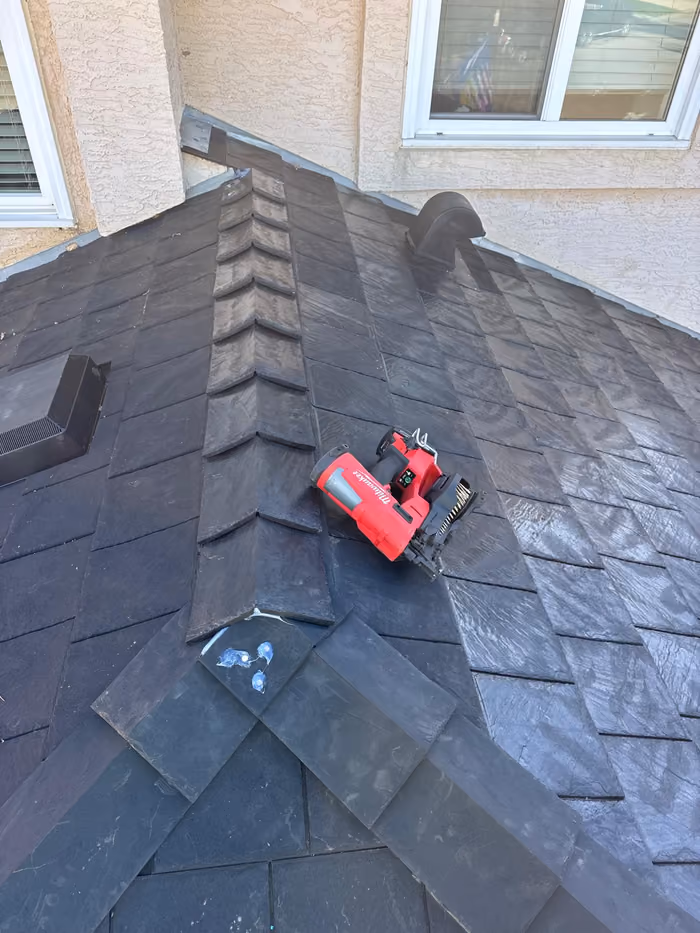 Synthetic slate hip cap installed with nail gun