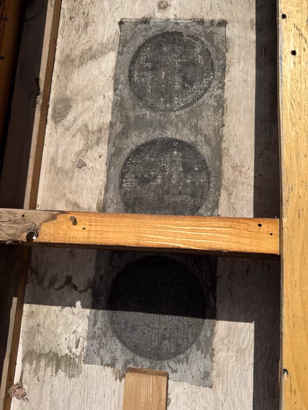 Water stained deck boards and rafter close up